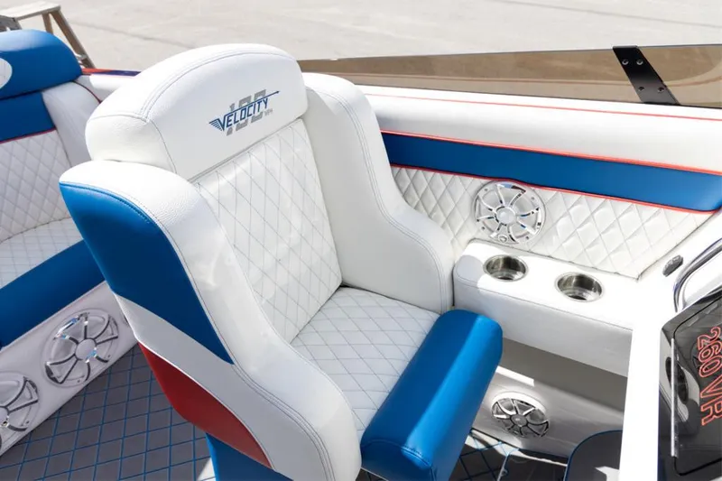 Slide: The Image of 2024 Velocity 260VR boat interior with white, blue, and red seating. - 4
