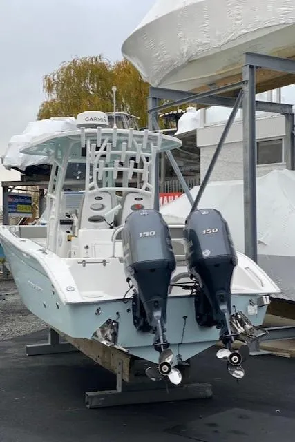 Slide: The Image of 2020 Cape Horn 24 XS boat with dual 150 HP engines, docked outdoors. - 16