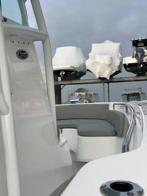 Slide: The Image of 2020 Cape Horn 24 XS boat interior with docked vessels in the background. - 18