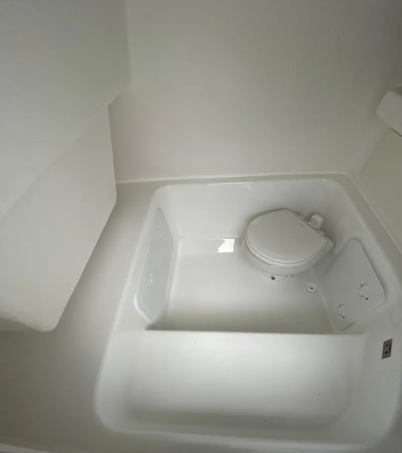 Slide: The Image of 2020 Cape Horn 24 XS boat interior with compact marine toilet. - 24