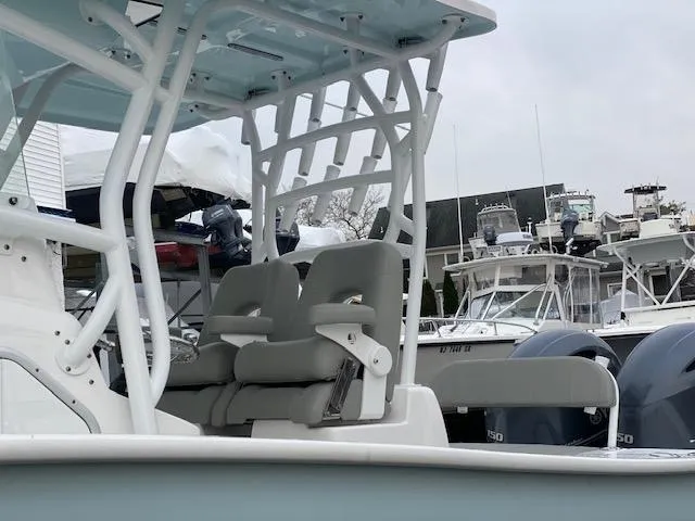 Slide: The Image of 2020 Cape Horn 24 XS boat with dual seats and sturdy frame, docked in a marina. - 7