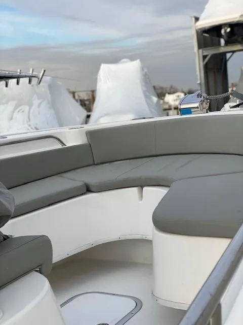 Slide: The Image of 2020 Cape Horn 24 XS boat with gray seating, docked under cloudy skies. - 17