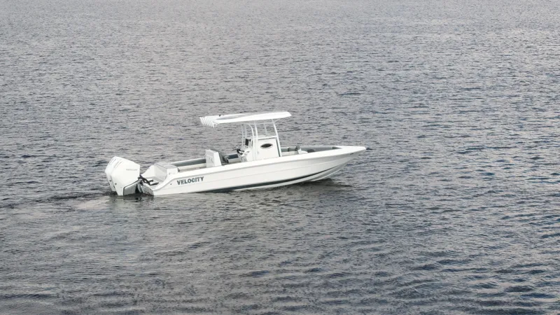 The Image of 2026 Velocity 262 CC boat on calm water, showcasing sleek design and twin engines. - 0