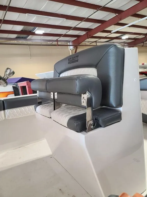 Slide: The Image of 2024 Velocity 262 CC boat with premium seating in a showroom. - 10