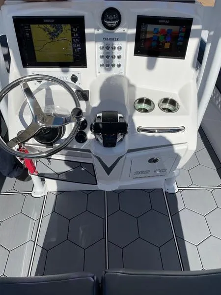 Slide: The Image of 2026 Velocity 262 CC boat dashboard with dual screens and steering wheel. - 13