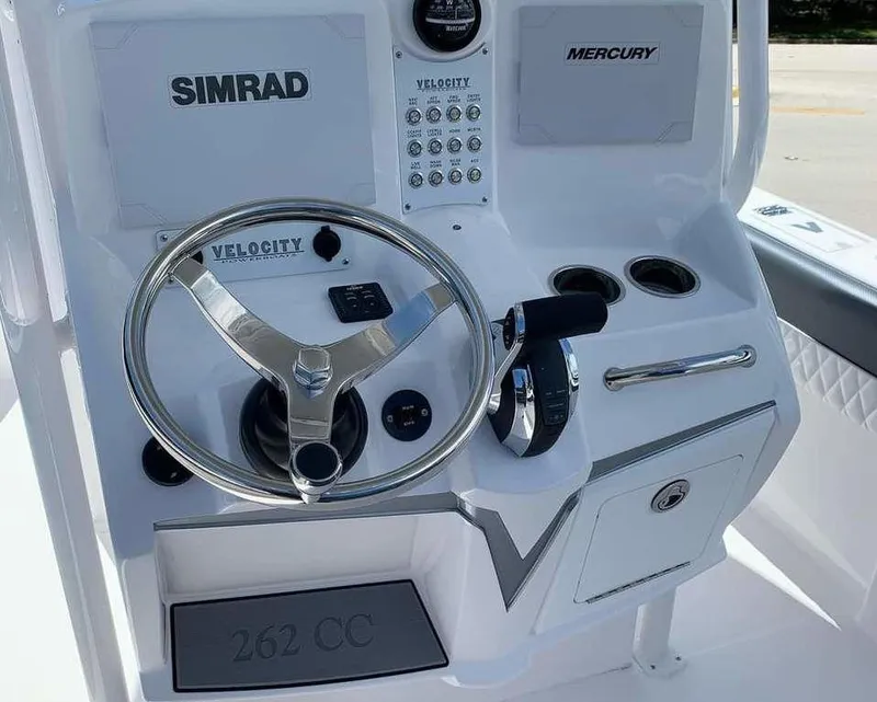 Slide: The Image of 2024 Velocity 262 CC boat console with Simrad and Mercury controls. - 14