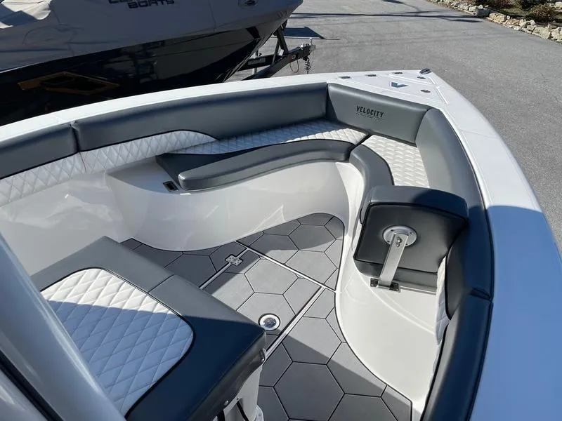 Slide: The Image of 2026 Velocity 262 CC boat interior with gray seating and hexagonal flooring. - 16