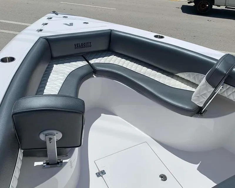 Slide: The Image of 2024 Velocity 262 CC boat with cushioned seating and storage compartments. - 17