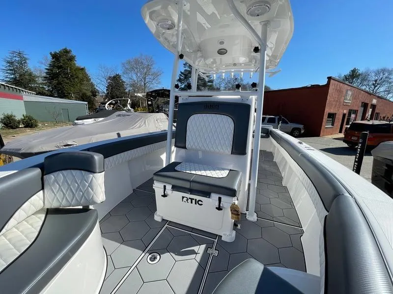 Slide: The Image of 2026 Velocity 262 CC boat interior with cushioned seating and RTIC cooler. - 18