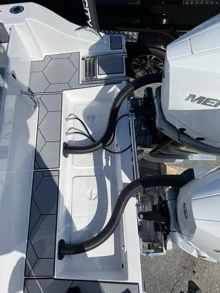 Slide: The Image of 2026 Velocity 262 CC boat deck with dual engines and hexagonal flooring design. - 19