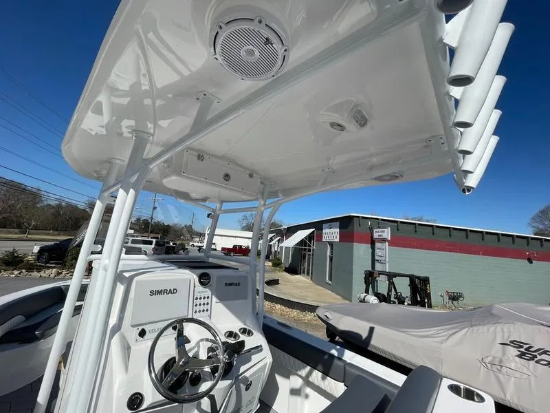 Slide: The Image of 2026 Velocity 262 CC boat console with Simrad electronics, under a clear blue sky. - 5