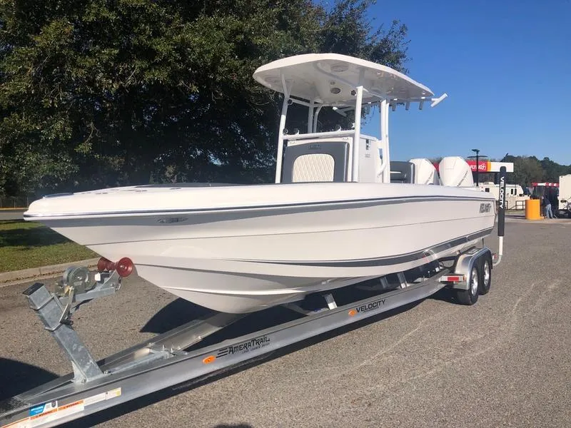 Slide: The Image of 2026 Velocity 262 CC boat on trailer, parked outdoors in sunny setting. - 7