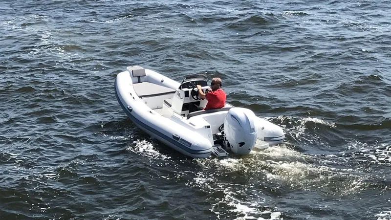 Slide: The Image of 2024 Northstar Axis 4.8 boat on water with person driving. - 3