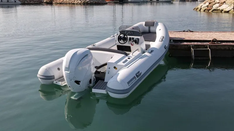 Slide: The Image of 2024 Northstar Axis 4.8 inflatable boat docked in calm waters. - 5