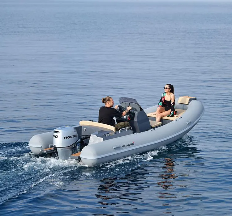 Slide: The Image of 2024 Northstar Axis 4.8 boat cruising on calm water with two passengers. - 8