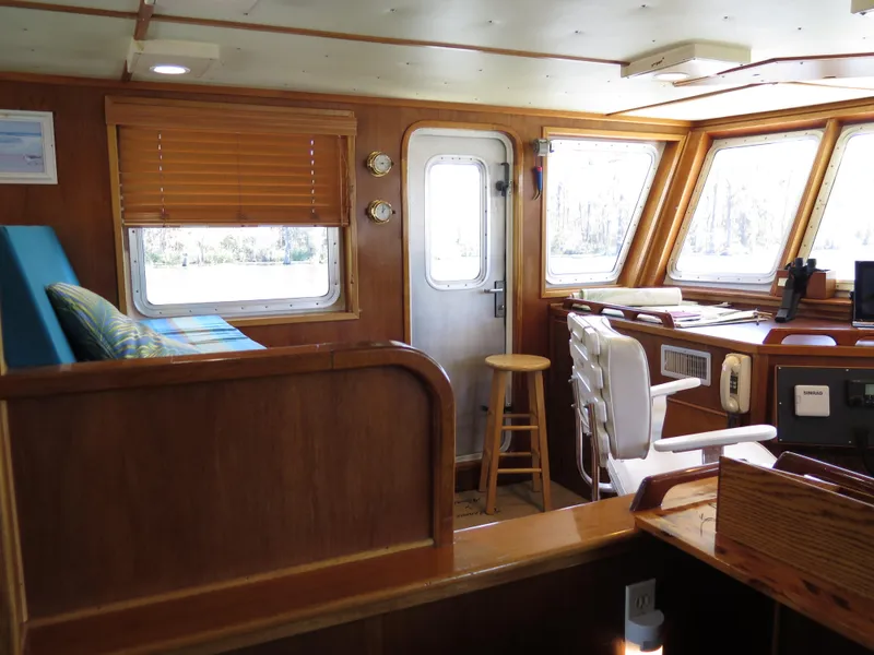 Slide: The Image of Interior of 1998 Rodriquez Custom boat with wooden furnishings and navigation equipment. - 10