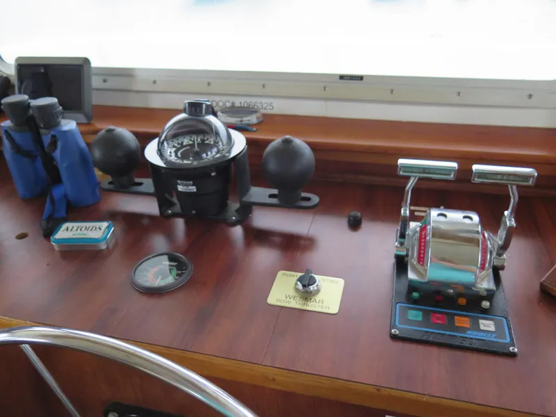 Slide: The Image of Control panel of a 1998 Rodriquez Custom boat with compass and throttle levers. - 13
