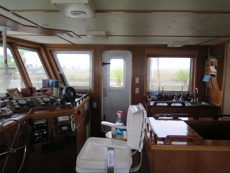 Slide: The Image of Interior of 1998 Rodriquez Custom boat with helm, seating, and kitchen area. - 14