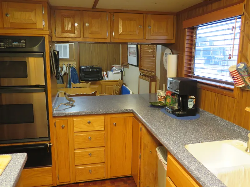 Slide: The Image of 1998 Rodriquez Custom kitchen with wooden cabinets, double oven, and countertop appliances. - 20