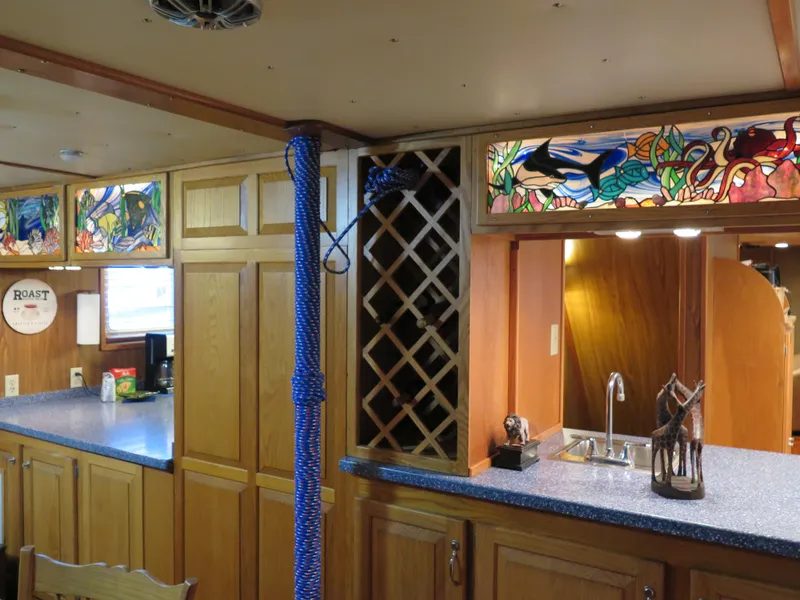 Slide: The Image of 1998 Rodriquez Custom yacht interior with stained glass cabinets and blue countertops. - 27
