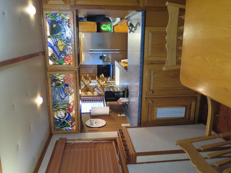 Slide: The Image of 1998 Rodriquez Custom kitchen with stained glass cabinets and wooden furniture. - 33