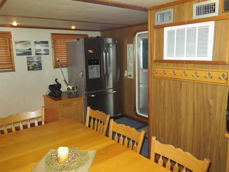 Slide: The Image of 1998 Rodriquez Custom interior with dining area, refrigerator, and wooden decor. - 38