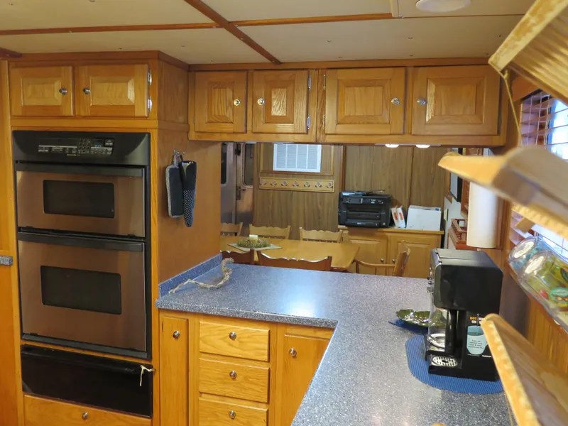 Slide: The Image of 1998 Rodriquez Custom kitchen with wooden cabinets, double oven, and blue countertops. - 43