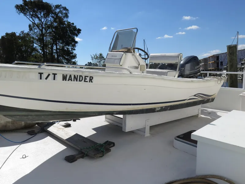 Slide: The Image of 1998 Rodriquez Custom boat T/T Wander docked on a sunny day. - 5