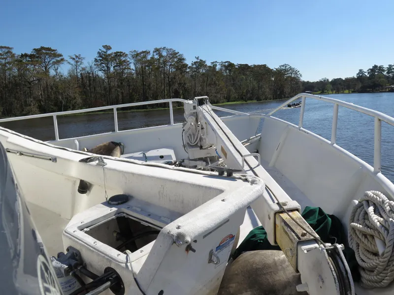 Slide: The Image of Rodriquez Custom 1998 boat deck with river and forest background. - 6