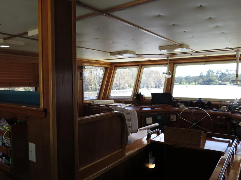 Slide: The Image of Interior of a 1998 Rodriquez Custom boat with wooden finishes and large windows. - 9