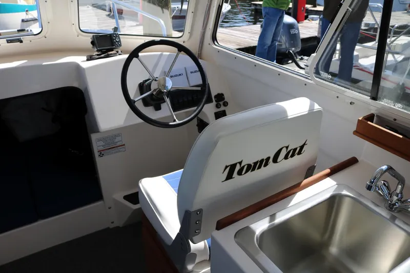Slide: The Image of Interior of 2026 C-Dory TOMCAT 255 boat with steering wheel and sink. - 8