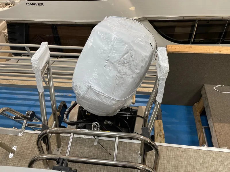 Slide: The Image of 2022 SunChaser Geneva Cruise 22 LR PSB boat engine covered in protective wrap. - 8