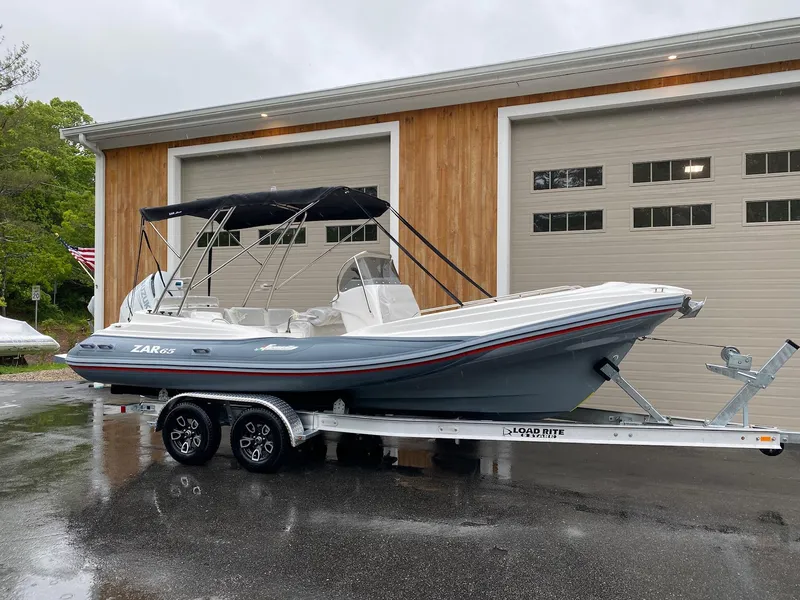 Slide: The Image of 2023 Zar Formenti Zar 65 boat on trailer in front of garage. - 10