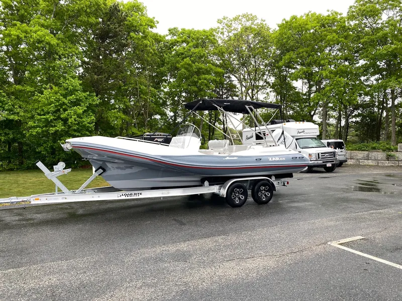 Slide: The Image of 2023 Zar Formenti Zar 65 boat on a trailer in a parking lot. - 11