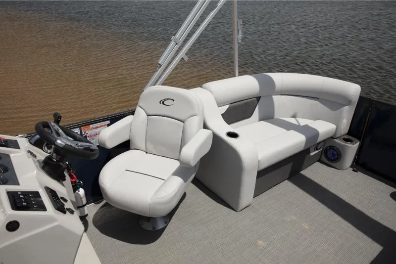 Slide: The Image of 2023 Crest Classic LX boat interior with white captain's chair and curved seating. - 16