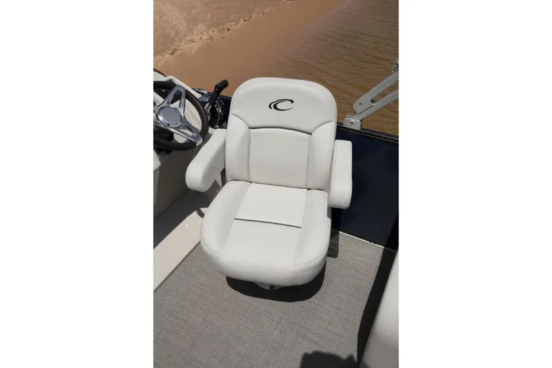 Slide: The Image of 2023 Crest Classic LX boat captain's chair with armrests and steering wheel. - 17