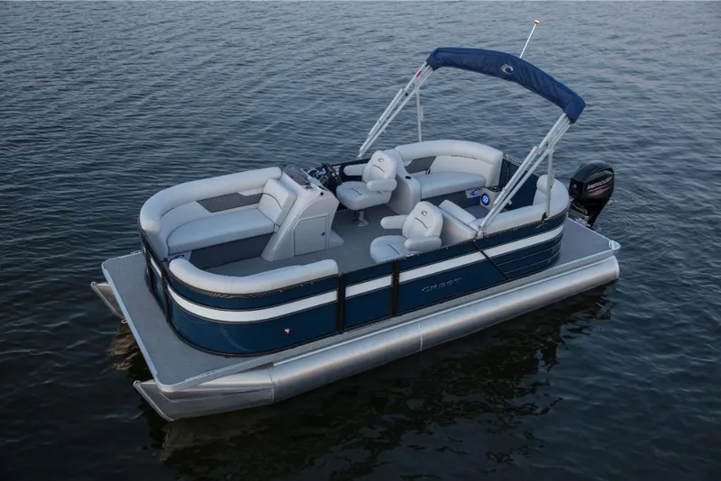 Slide: The Image of 2023 Crest Classic LX pontoon boat on calm water. - 2