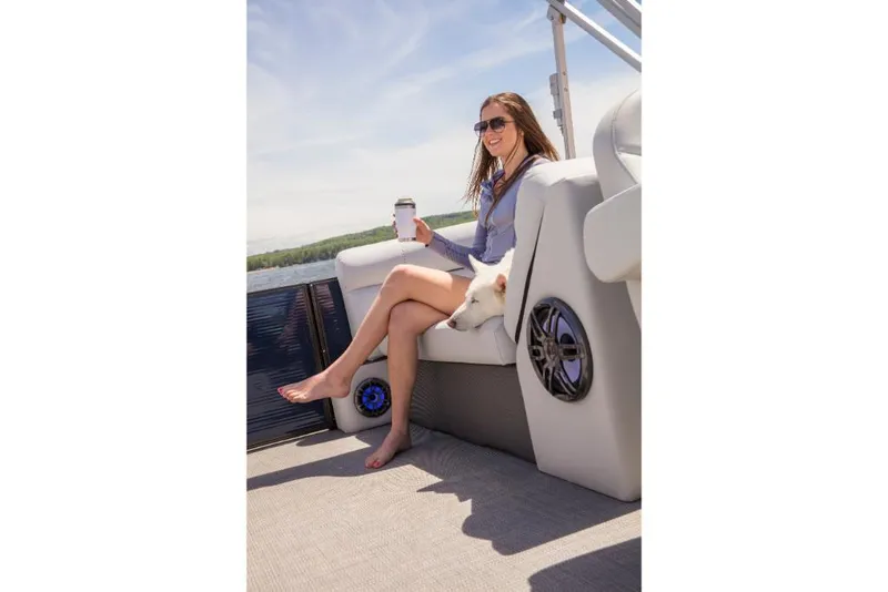 Slide: The Image of Woman relaxing on 2023 Crest Classic LX boat with a dog and coffee. - 22