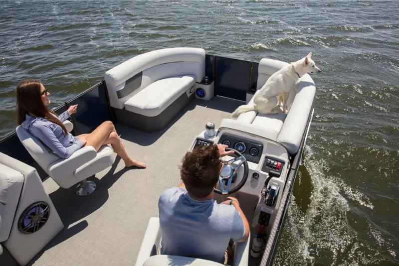 Slide: The Image of 2023 Crest Classic LX boat with people and a dog on a lake. - 26
