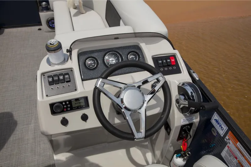 Slide: The Image of 2023 Crest Classic LX boat dashboard with steering wheel and control panel. - 9