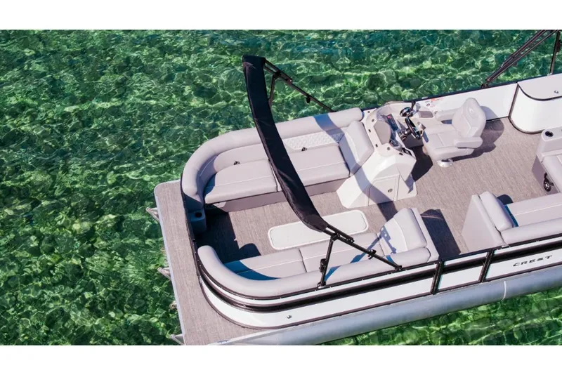 Slide: The Image of 2023 Crest Classic DLX pontoon boat on clear water. - 2