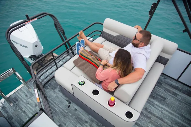 Slide: The Image of Couple relaxing on a 2023 Crest Classic Platinum boat with Mercury outboard engine. - 26