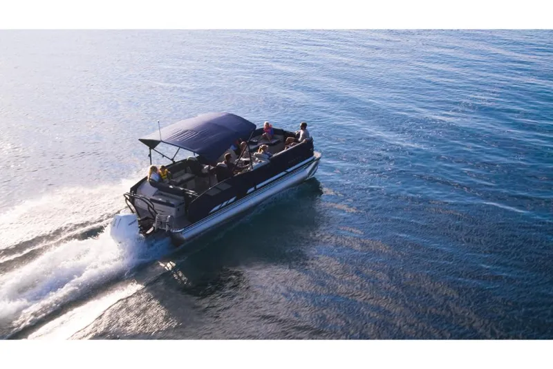 Slide: The Image of 2023 Crest Caribbean LX pontoon boat cruising on open water. - 0