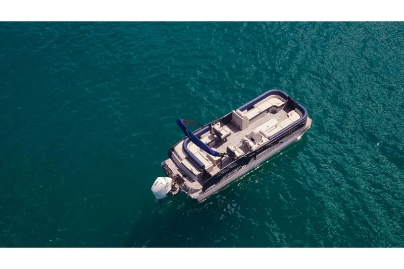 Slide: The Image of Aerial view of 2023 Crest Caribbean LX boat on clear blue water. - 2