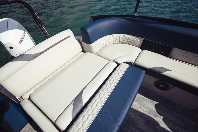 Slide: The Image of 2023 Crest Caribbean LX boat interior with luxurious seating and Mercury outboard motor. - 5