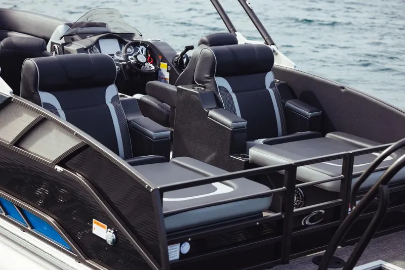 Slide: The Image of 2023 Crest Caribbean RS boat interior with luxurious black seating and modern dashboard. - 2