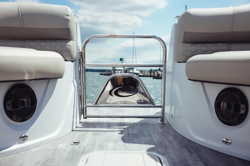 Slide: The Image of 2023 Crest Savannah 270 boat interior with cushioned seating and water view. - 8