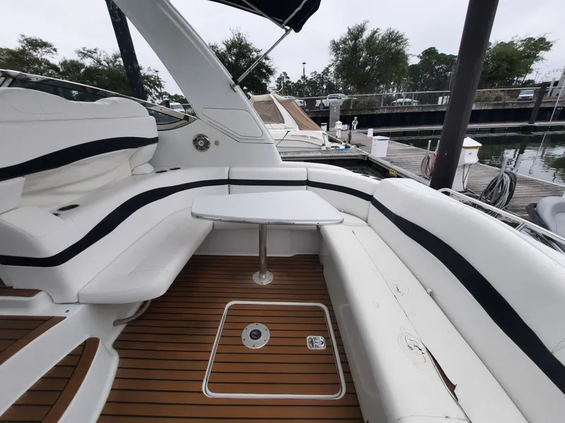 Slide: The Image of 2008 Formula 40 PC yacht with white seating and wooden deck at a marina. - 10