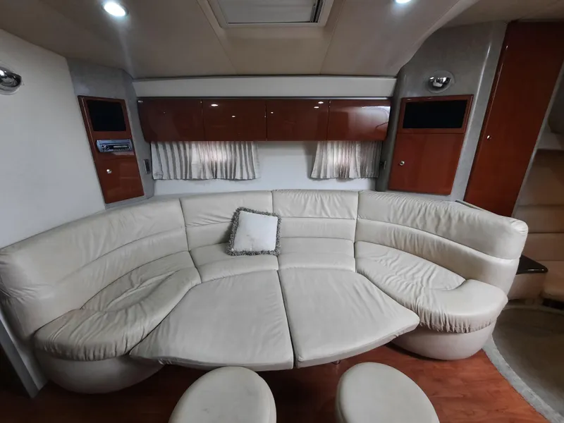 Slide: The Image of 2008 Formula 40 PC yacht interior with curved leather seating and wooden cabinets. - 19