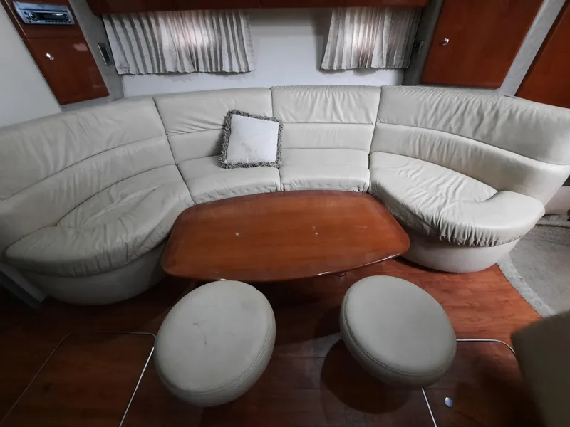 Slide: The Image of 2008 Formula 40 PC yacht interior with curved leather seating and wooden table. - 20